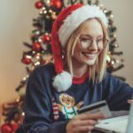 Woman online shopping. Close up of a young woman buying presents online.